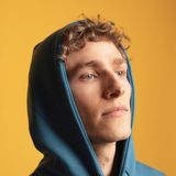 Profile picture of Dylan Hand wearing green hoodie with yellow background