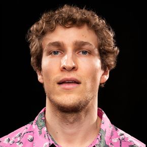 Made It There cover art: studio photo of Dylan Hand wearing pink alligator shirt and rather blank expression