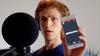 Picture of Dylan Hand holding phone with random word generator app