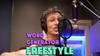 Picture of Dylan Hand in front of microphone wearing headphones