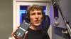 Picture of Dylan Hand at micrphone showing phone with word generator app RapScript